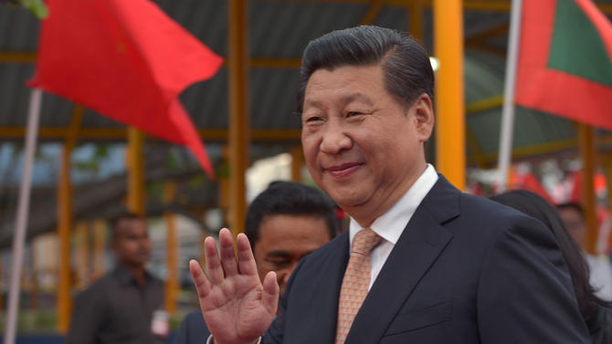 Chinese President Xi Jinping waves upon his arrival at the Ibrahim Nasir International Airport in Hulhule on September 14, 2014, in the Maldives